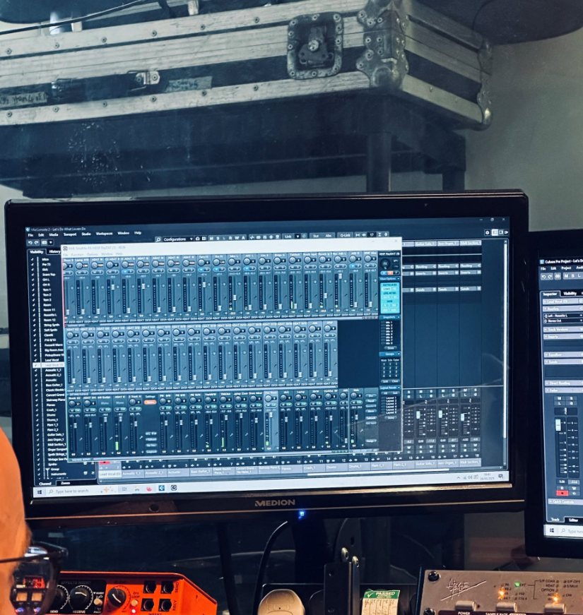 A Cubase mixing session on a studio monitor, with flight cases stacked above and rack gear below